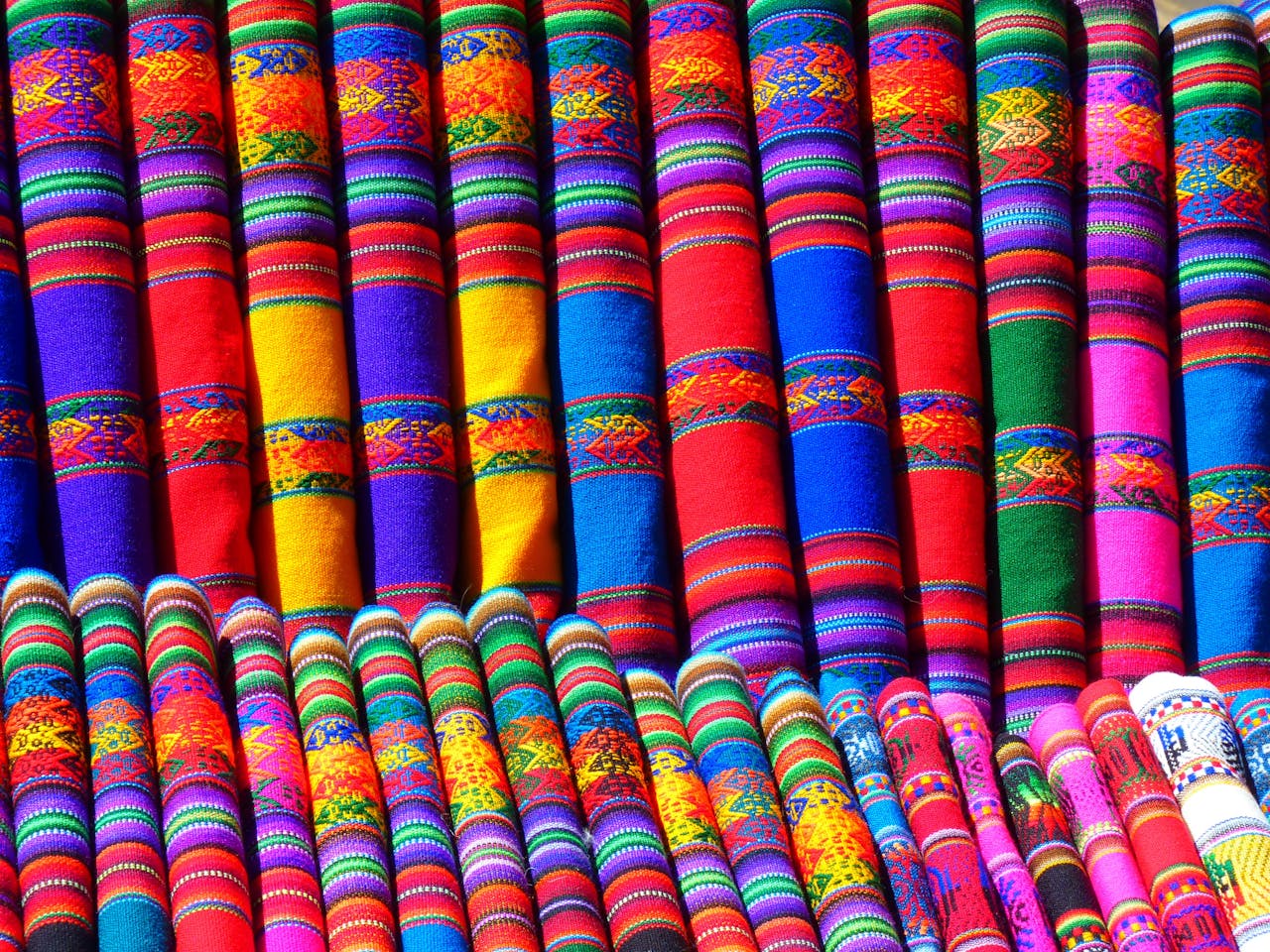 Colorful traditional textiles showcasing intricate geometric patterns and rich cultural heritage.